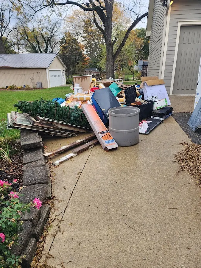 Dumpster being loaded with debris for Estate Cleanout Dumpster Rental in Franklin